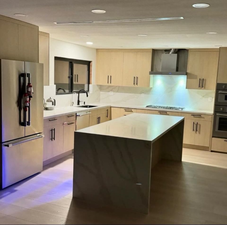 Completed light wood and white kitchen with illuminated island