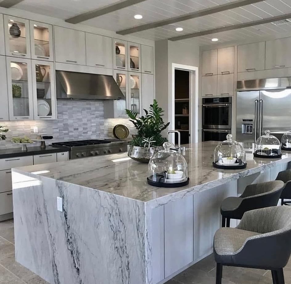 Completed white kitchen with marble waterfall island