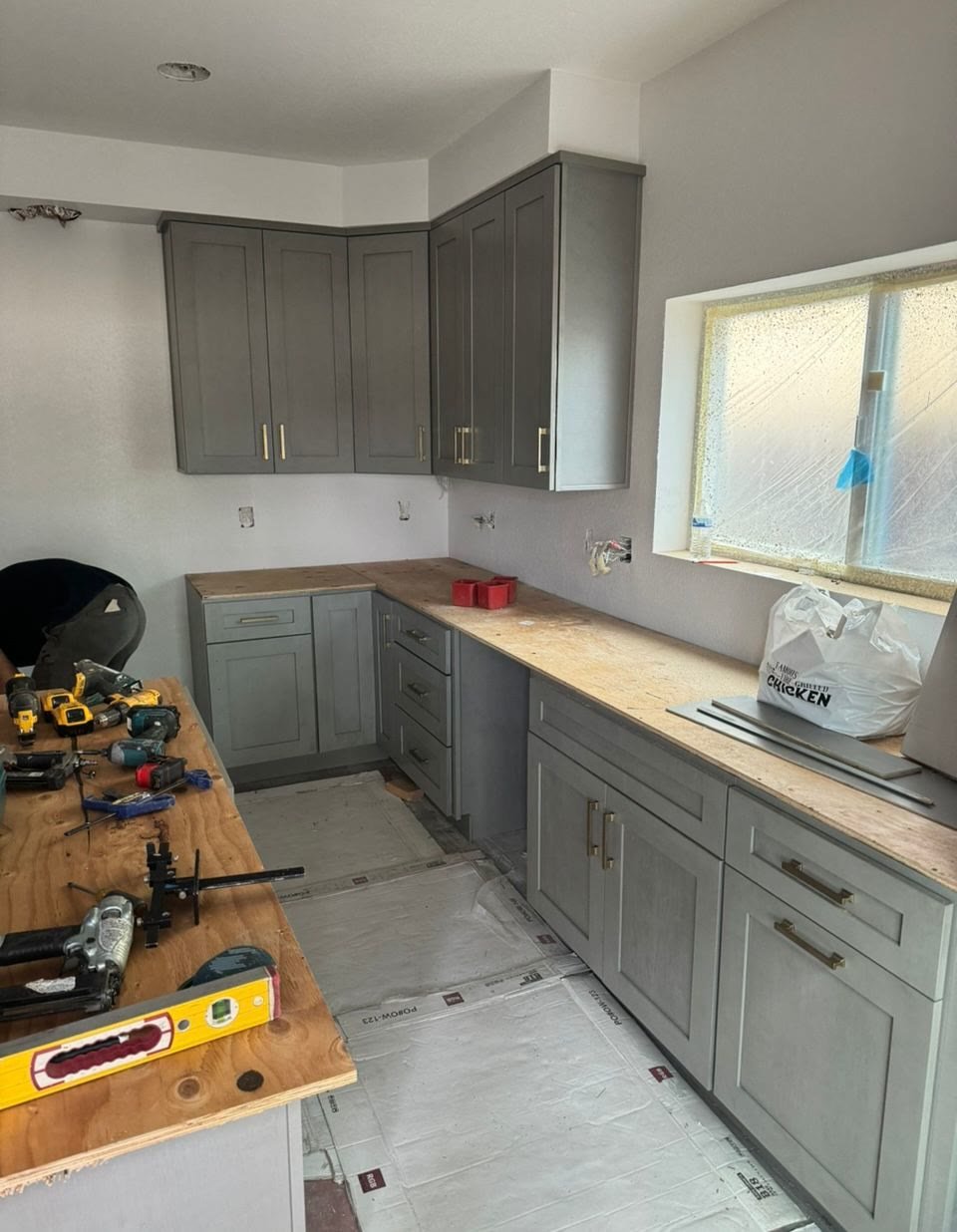 Gray cabinets with temporary butcher-block counters