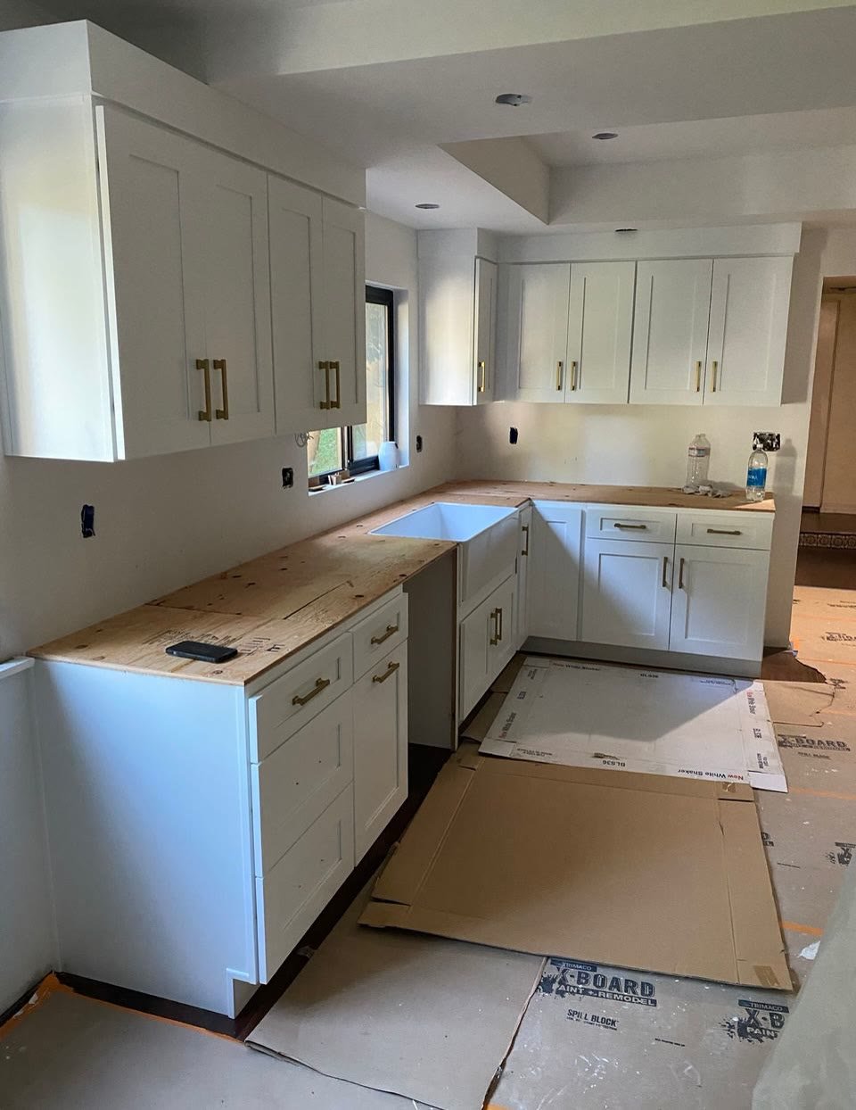 White kitchen cabinet installation in progress